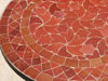 Detailed view of a handmade round coffee table with a colorful mosaic design, highlighting its Moroccan heritage and artistry.