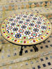 Handmade Moroccan mosaic coffee table with vibrant colors and patterns, set on a rustic stone floor, perfect for any decor.