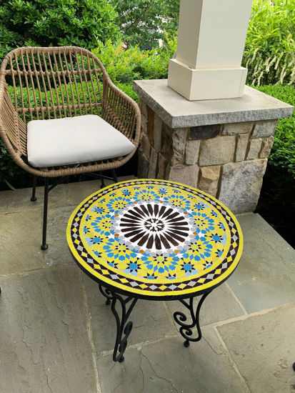 Yellow and black mosaic table, showcasing Moroccan craftsmanship and mid-century design for indoor or outdoor use.