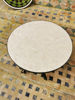 Stylish round table with a marble surface, highlighting the beauty of customizable Moroccan mosaic craftsmanship.