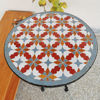 A vibrant Moroccan tile table adorned with a plant, featuring intricate zellige designs, perfect for home decor.