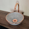 Handcrafted white ceramic sink with a solid copper rim and fishscale design, featuring a stylish copper faucet above it.