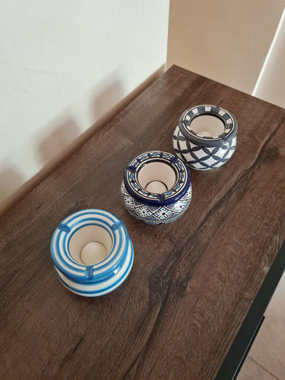 Three handpainted Moroccan ceramic ashtrays on a table, showcasing vibrant colors and intricate designs, perfect for decor or gifts.
