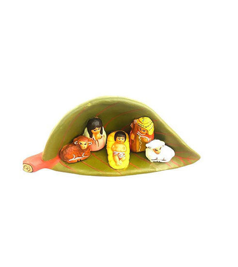 Vintage nativity scene featuring the Holy Family nestled inside a decorative leaf, handcrafted from natural clay by Peruvian artisans.