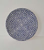 A 14-inch blue and white Moroccan ceramic wall plate featuring intricate geometric designs, showcasing traditional craftsmanship.