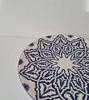 A vibrant 14-inch Moroccan ceramic plate, hand-painted in blue and white, perfect for dining or as a decorative wall piece.
