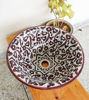 Hand-painted burgundy ceramic vessel sink with intricate Moroccan designs, showcasing mid-century modern style and artistry.