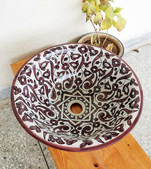 Hand-painted burgundy ceramic vessel sink with intricate Moroccan designs, showcasing mid-century modern style and artistry.