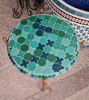 Handmade green and gold mosaic table with a copper base, blending Moroccan artistry with modern design for versatile use.