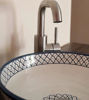 Artisan-made blue and white bowl featuring detailed Moroccan designs, perfect for adding elegance to any bathroom or kitchen.