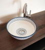 Unique blue and white ceramic sink with rich patterns, handcrafted in Morocco, ideal for enhancing bathroom aesthetics.
