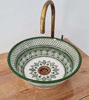 Unique green and white ceramic sink with a gold faucet, hand-painted in Moroccan style, perfect for modern or eclectic bathrooms.