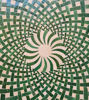 Close-up of a Green and white Moroccan mosaic table, showcasing intricate tilework for indoor or outdoor use.