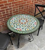 Colorful round Moroccan mosaic table with intricate Zellige tile design, perfect for indoor or outdoor use.