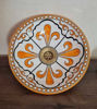 Decorative orange and white ceramic bowl with a brass rim, showcasing Moroccan craftsmanship and vibrant hand-painted design.