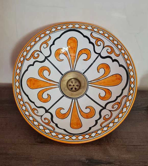 Decorative orange and white ceramic bowl with a brass rim, showcasing Moroccan craftsmanship and vibrant hand-painted design.