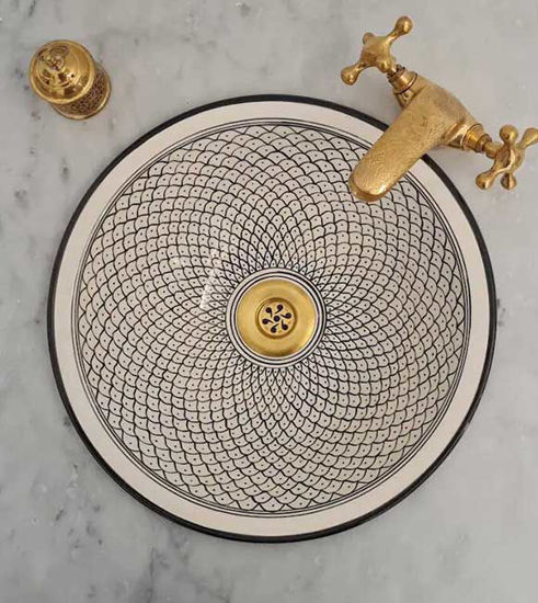 Handcrafted gold and black ceramic sink with a fish-scale pattern and gold faucet, showcasing Moroccan artistry and elegance.