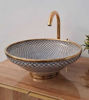 Artisan-crafted Fez Blue ceramic vanity sink featuring a gold faucet and minimalist fish scale pattern, perfect for a farmhouse bathroom.