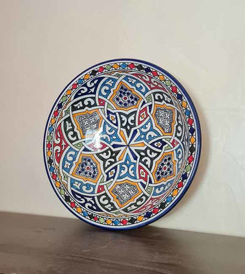 Colorful handmade Moroccan ceramic plate featuring vibrant patterns, showcasing authentic craftsmanship and artistic design.