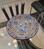 Handmade Moroccan ceramic plate with colorful designs, highlighting traditional artistry and perfect for enhancing table settings.
