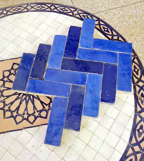 Handmade navy and royal blue Zellige terracotta tiles with a unique pattern, perfect for kitchens and bathrooms.