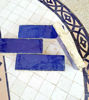 Close-up of a blue patterned Zellige tile floor, showcasing handmade terracotta tiles in deep navy and royal blue hues.