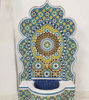 Colorful mosaic fountain featuring blue and yellow tiles, showcasing intricate designs, perfect for outdoor or indoor spaces.
