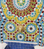A striking blue and yellow mosaic fountain, handcrafted in Morocco, ideal for enhancing outdoor or indoor tranquil settings.