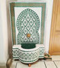 Rustic Moroccan mosaic fountain featuring green and white tiles, designed to enhance gardens or indoor areas with flowing water sounds.