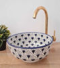 Hand-painted blue and white ceramic bowl featuring sunflower designs, showcasing Moroccan artistry and mid-century modern style.