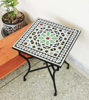 Vibrant mosaic table on a patio, featuring customizable colors and shapes, reflecting traditional Moroccan craftsmanship.