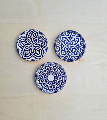 Set of three blue and white ceramic plates featuring unique designs, reflecting traditional Moroccan pottery artistry.
