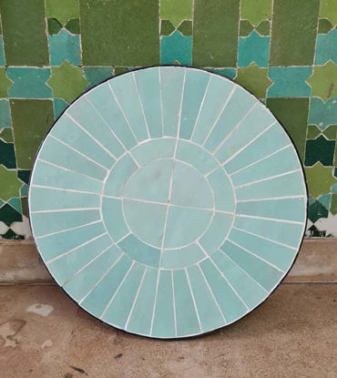 Vibrant turquoise tile table with a circular mosaic design, perfect for indoor or outdoor decor, reflecting Moroccan artistry.