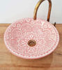 Elegant pink and white ceramic sink featuring a golden faucet, highlighting unique Moroccan artistry and vintage charm.
