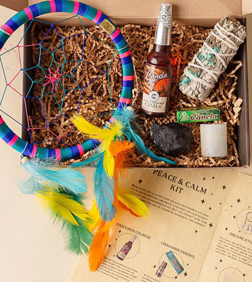 A ritual kit box containing a dream catcher, crystal, sage bundle, essence etc. designed for energy cleansing and inner peace.