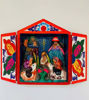 Handmade Peruvian retablo featuring a colorful Nativity scene of the Holy Family, crafted from wood and natural paints.