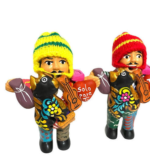 Two handcrafted ceramic figurines of a man and woman holding a guitar, symbolizing abundance and prosperity in Peruvian culture.