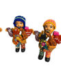 Handcrafted ceramic figurines of a man and woman with a guitar, embodying the spirit of abundance and luck in Peruvian tradition.