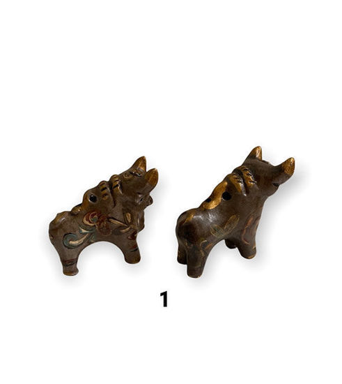 Two handmade Peruvian bull figurines, symbolizing protection and good fortune, with vibrant Andean designs and clay craftsmanship.