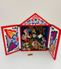 A wooden box showcases vibrant, handcrafted figurines representing Peruvian cultural scenes and festive dances from the Andes.