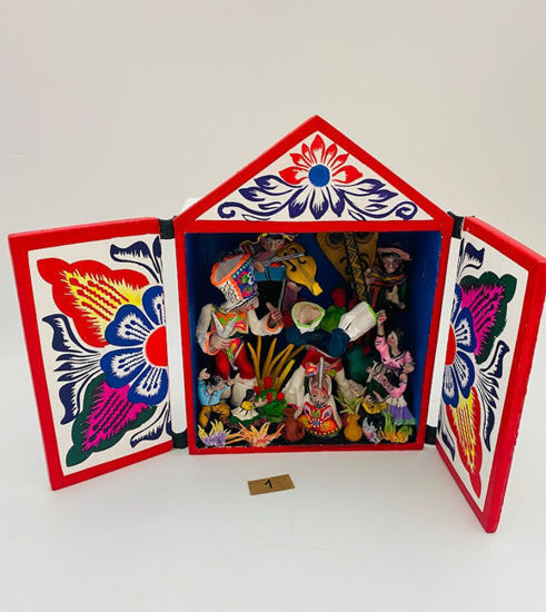 A wooden box showcases vibrant, handcrafted figurines representing Peruvian cultural scenes and festive dances from the Andes.