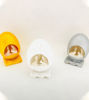 Three small eggs with tiny figures inside, representing the Holy Family in a handcarved white stone nativity scene.