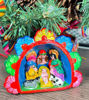 Miniature Peruvian nativity scene ornament featuring the Holy Family, crafted from clay with natural pigments.