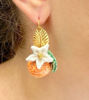 Picture of Orange earrings with white flower and leaf