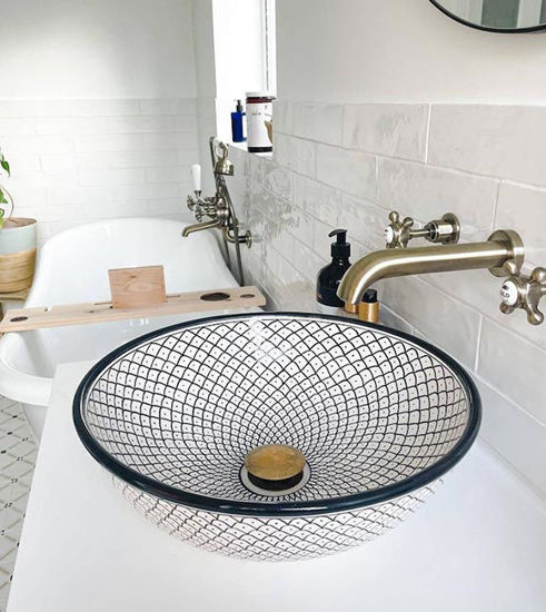Handmade black and white Moroccan ceramic sink with intricate patterns, showcasing Mediterranean artistry and elegance.