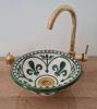 Handmade dark green ceramic sink with a gold faucet, reflecting Moroccan artistry in a sleek Mid Century Modern style.