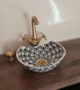 Black and white ceramic washbasin with intricate Moroccan patterns, featuring a gold faucet, ideal for luxury bathroom décor.