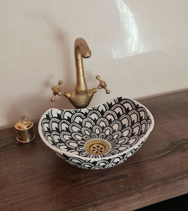 Black and white ceramic washbasin with intricate Moroccan patterns, featuring a gold faucet, ideal for luxury bathroom décor.