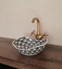 Elegant black and white ceramic washbasin with a gold faucet, showcasing unique Moroccan craftsmanship for luxury bathrooms.