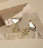 Two gold-tone earrings featuring white inverted triangle gemstones, showcasing intricate labyrinth-style metal detailing.